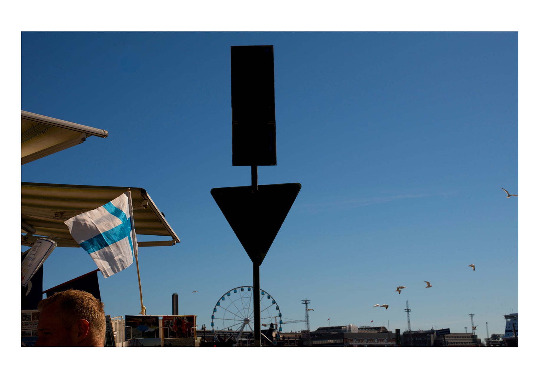 Geometrical shapes, blonde head and ferris wheel in Helsinki port